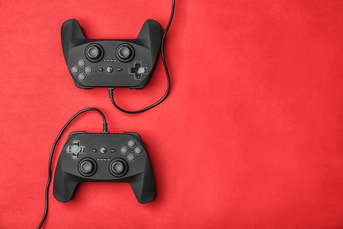 Video Game Controllers on Red Background